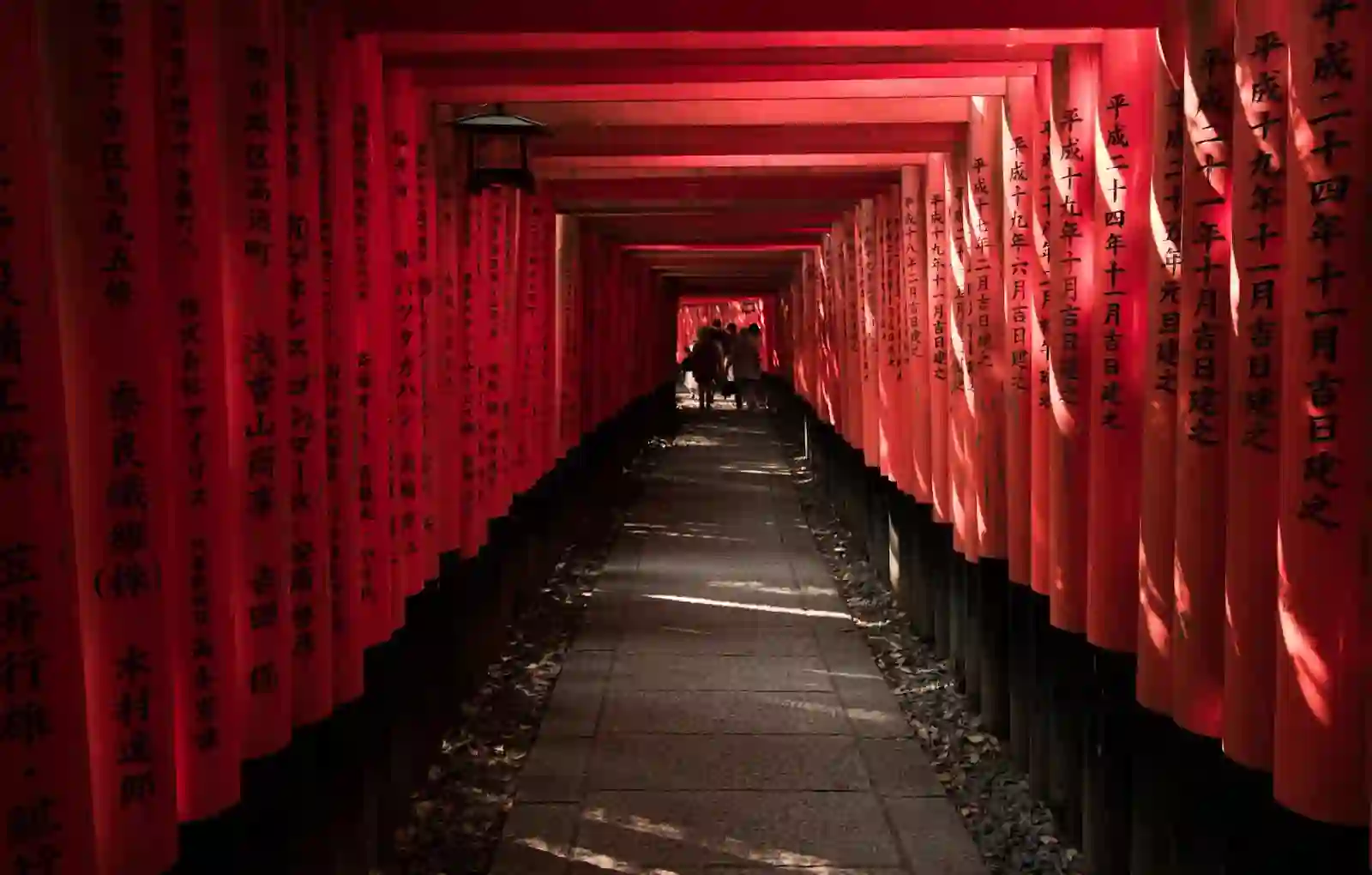 A path lined with thousands of vermillion torii gates at Fushimi Inari Taisha in Kyoto