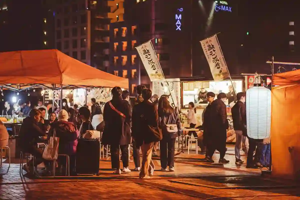 People gathered around a yatai food stall at night