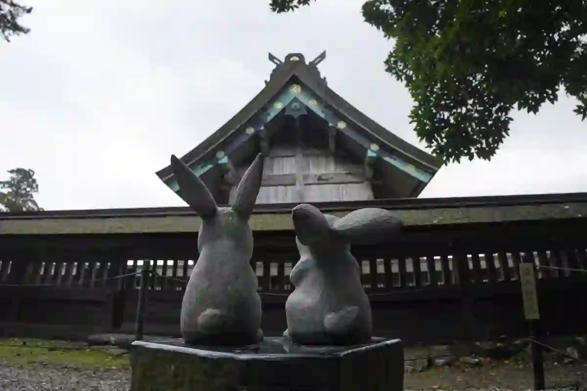 Stone rabbit statues in front of a temple building at Izumo Taisha